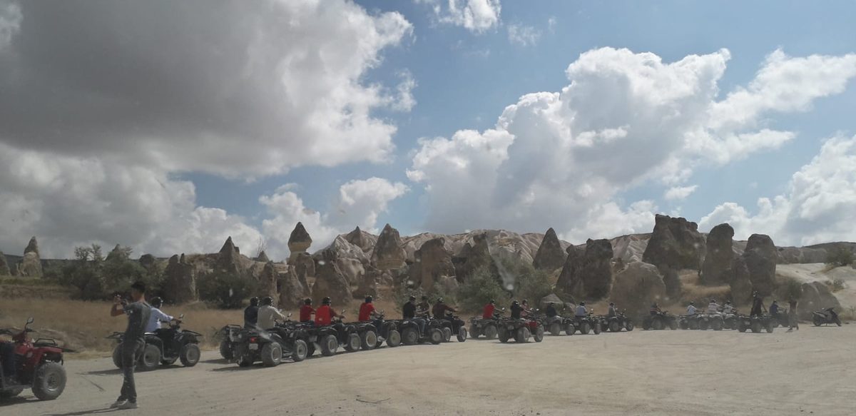 A line of ATV quad bikes setting off among the fairy chimneys near Göreme