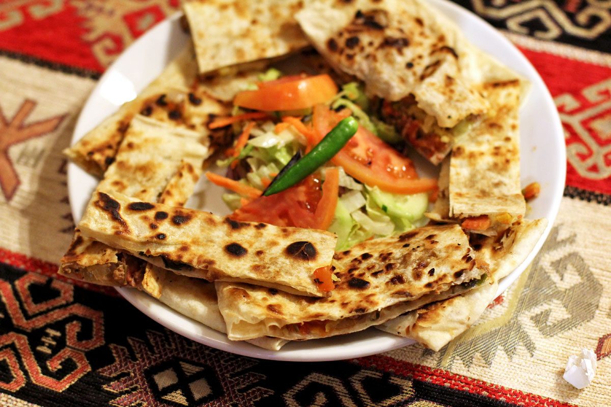 A plate of freshly griddled gözleme with salad, served in Cappadocia